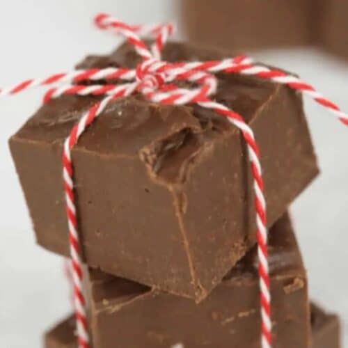 Three pieces of chocolate fudge stacked and tied with red and white string—perfect for homemade food gifts or other thoughtful gifts.