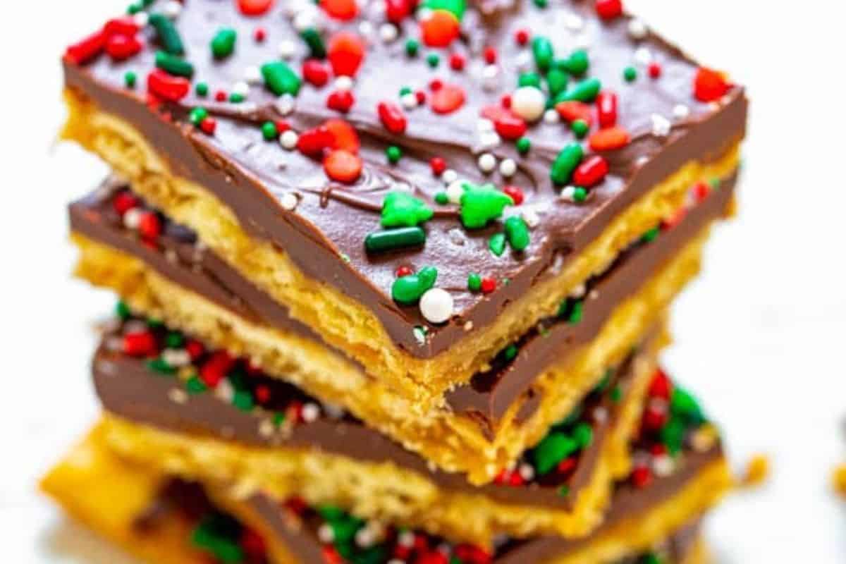 Toffee cracker bark topped with melted chocolate and red and green sprinkles.