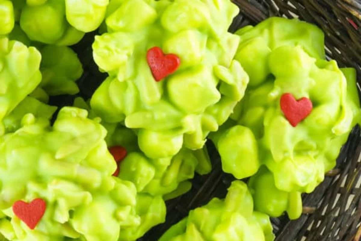 Chunks of rocky road candy with green candy melts, marshmallows, and chocolate pieces.