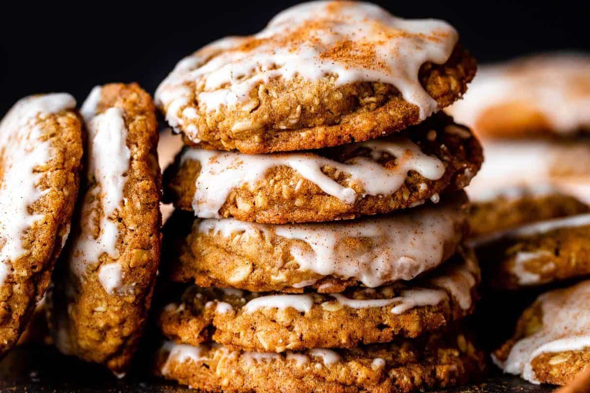 Oatmeal cookies flavored with gingerbread spices and topped with a white icing drizzle.