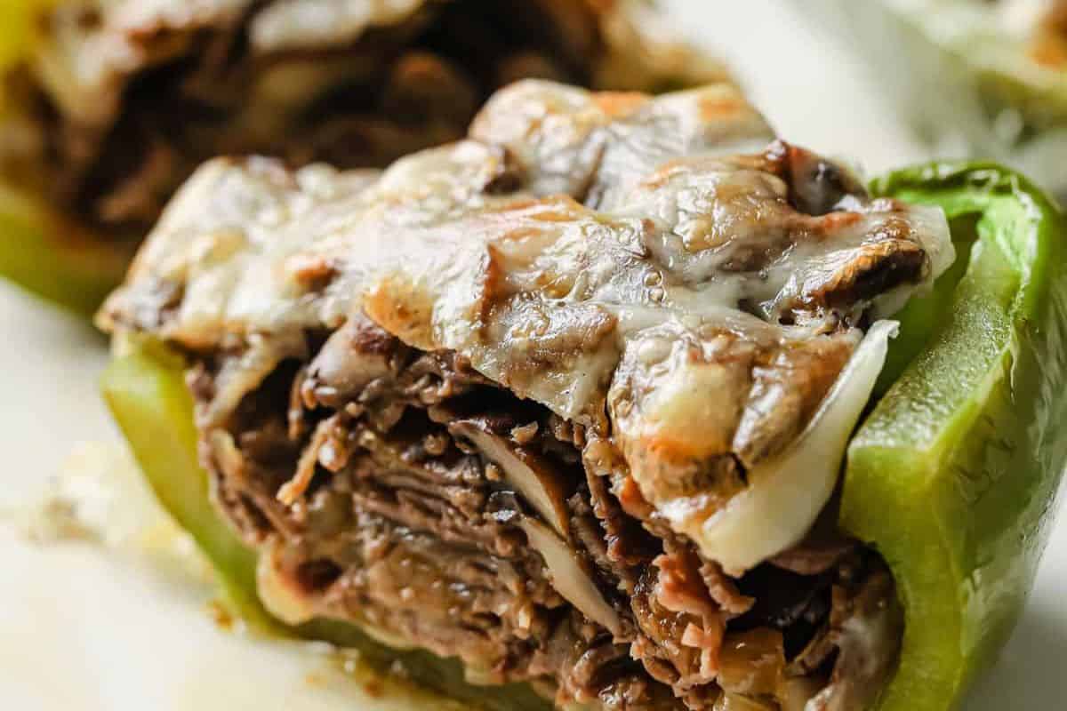 Close-up of a green bell pepper half stuffed with shredded beef and topped with melted cheese—perfect for easy stuffed peppers or quick weeknight dinners.