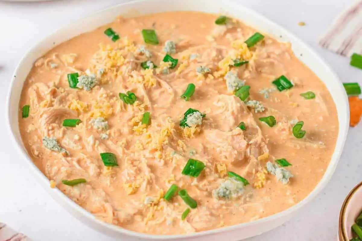 Instant pot buffalo chicken dip in a white bowl.