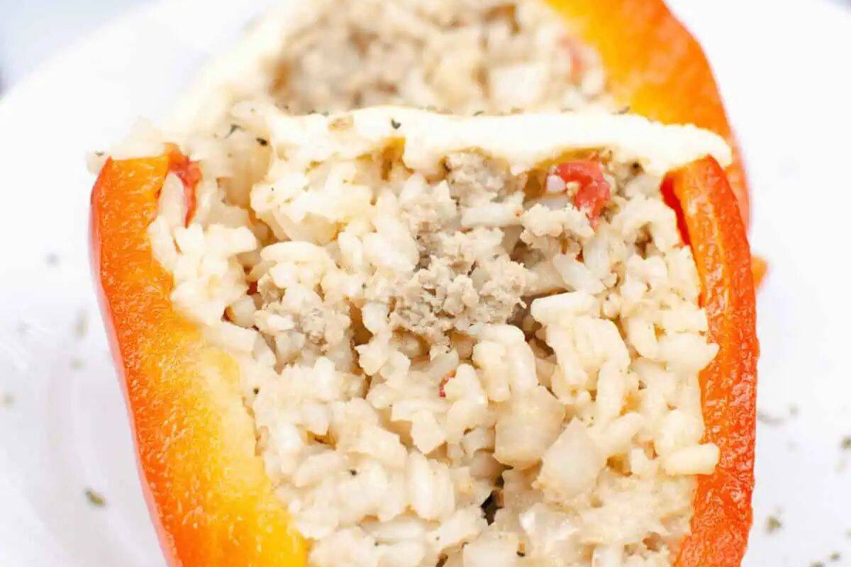 A red bell pepper half stuffed with a savory mixture of cooked rice, ground meat, and diced vegetables, then topped with melted cheese—perfect for easy stuffed peppers or quick weeknight dinners.