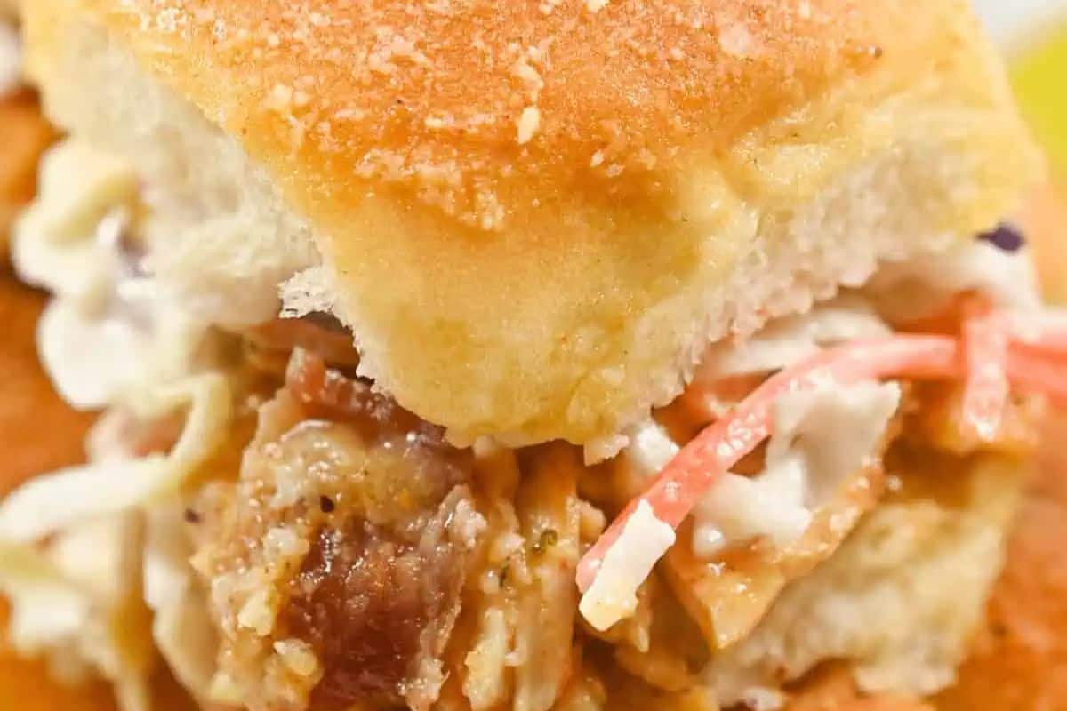 Close-up of an irresistible BBQ chicken slider with coleslaw on a soft bun, perfect for Game Day feasting.