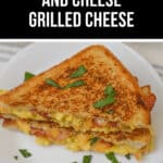 A Bacon Egg and Cheese Grilled Cheese sandwich garnished with herbs sits invitingly on a white plate.