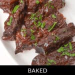 Country style beef ribs, perfectly baked and garnished with chopped parsley, are elegantly presented on a white platter.