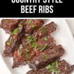 Indulge in our savory, baked country style beef ribs, beautifully garnished with fresh herbs and elegantly served on a pristine white plate.