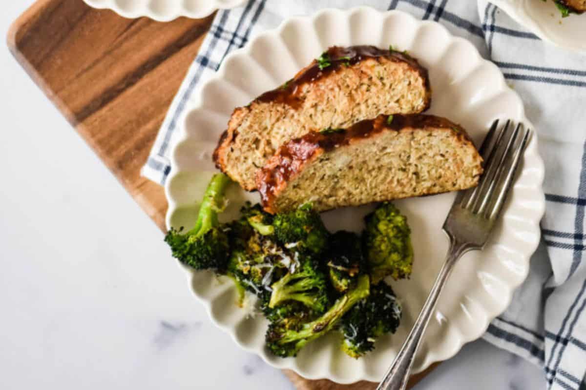 Slices of chicken meatloaf brushed with tangy barbecue sauce, served with roasted broccoli.