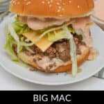 A plate features irresistible Big Mac Sloppy Joes, heaped with cheese, lettuce, and special sauce on a sesame seed bun. In the background, a bowl of extra sauce awaits for dipping delight.