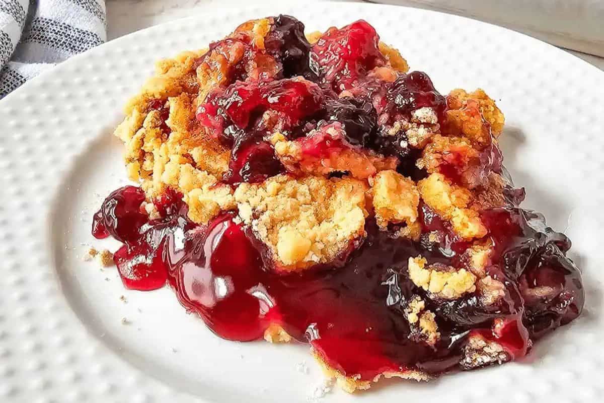 Close-up of a slice of blueberry cherry dump cake.
