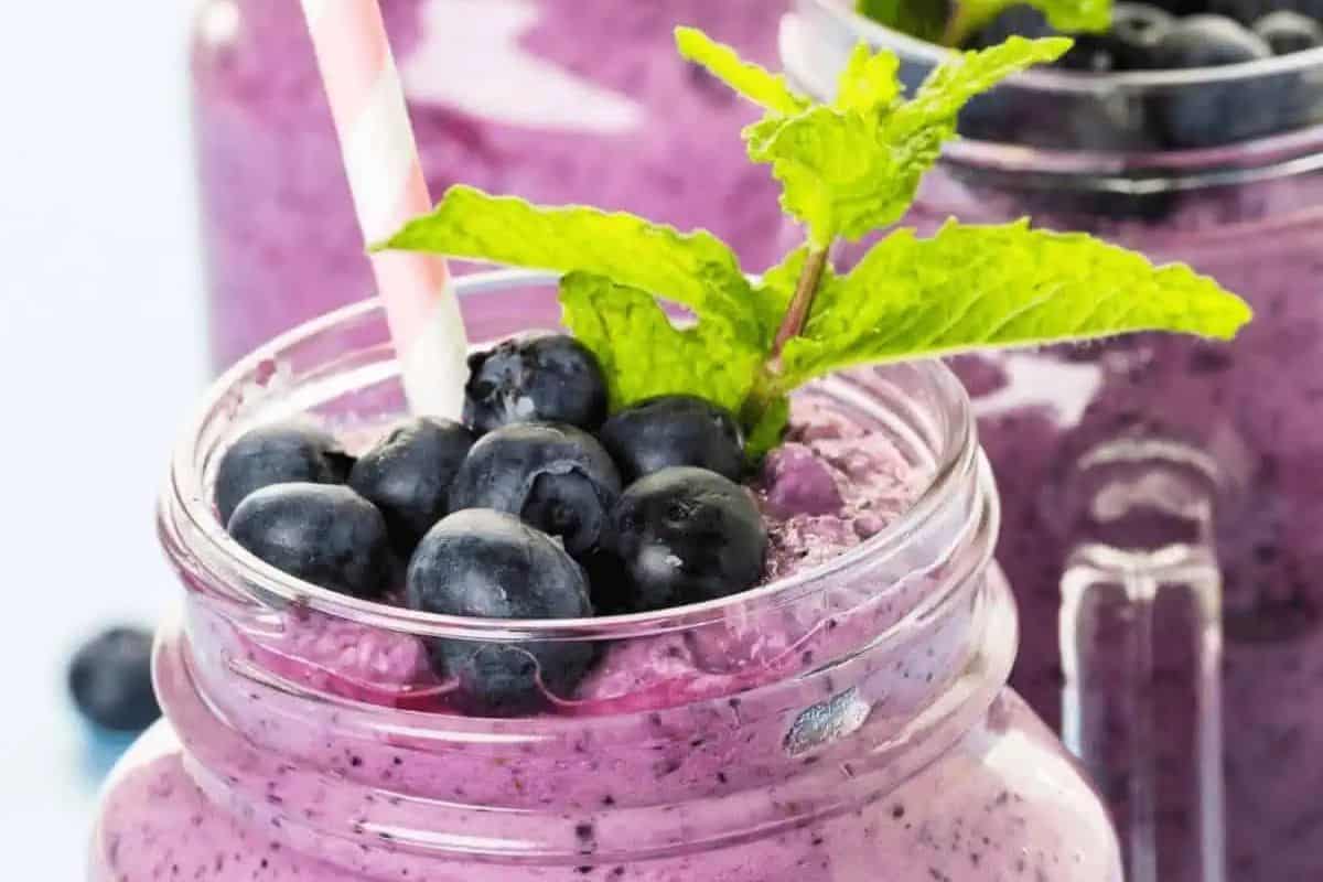 A Blueberry Pineapple Smoothie topped off with blueberries. 
