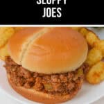 A Crock Pot Sloppy Joe sandwich on a bun is perfectly paired with a side of crispy tater tots, all served on a classic white plate.