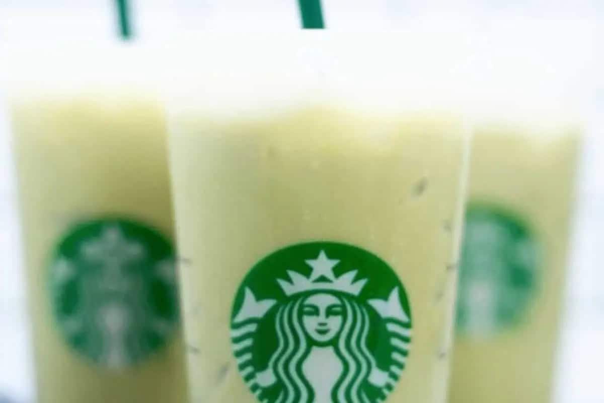 Three iced Starbucks Drinks in clear cups with green straws, each displaying the Starbucks logo, filled with a light green drink—perfect to recreate At Home for a refreshing coffeehouse experience.