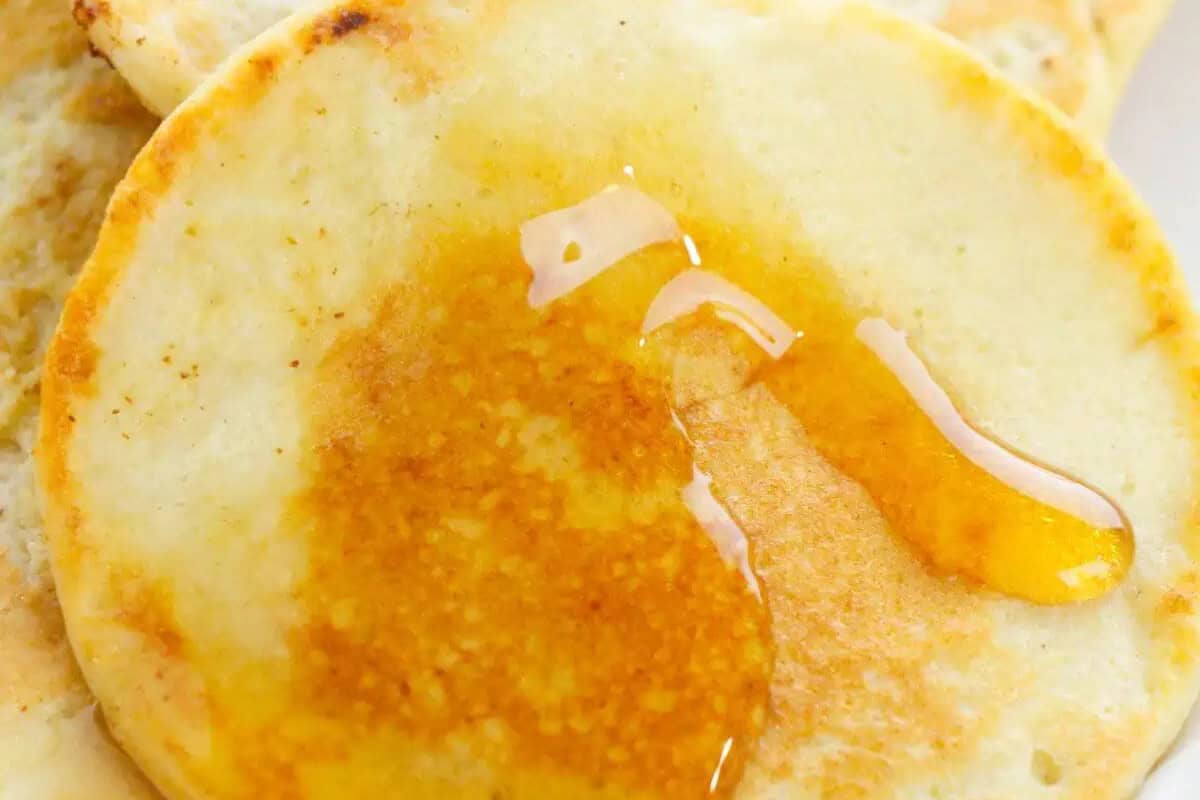 A close-up of a pancake with syrup drizzled on top, perfect for lazy mornings and indulgent weekend brunch.