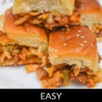 A mouthwatering stack of Easy Sloppy Joe Sliders, topped with sesame seeds, awaits you on a pristine white plate.