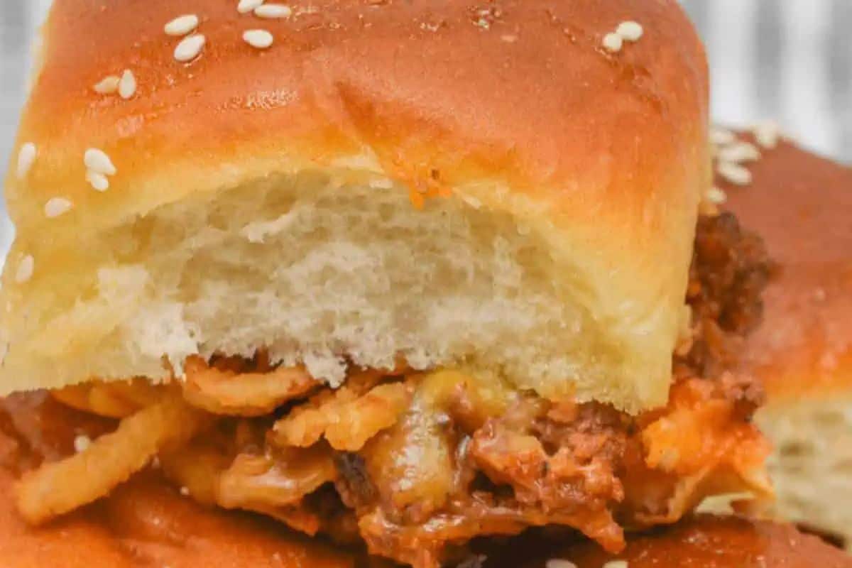An irresistible sloppy joe with layers of meat, melted cheese, and crispy onion nestled in a sesame seed bun—perfect for game day sliders.