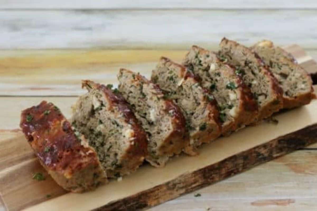 Turkey meatloaf packed with spinach, mushrooms, and feta cheese, sliced.