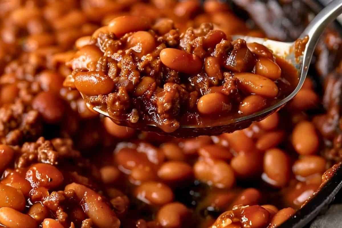 A spoonful of baked beans with ground beef in a rich sauce, this crowd-pleasing dish is perfect for potluck recipes or adding a savory twist to your St. Patrick's Day celebration.
