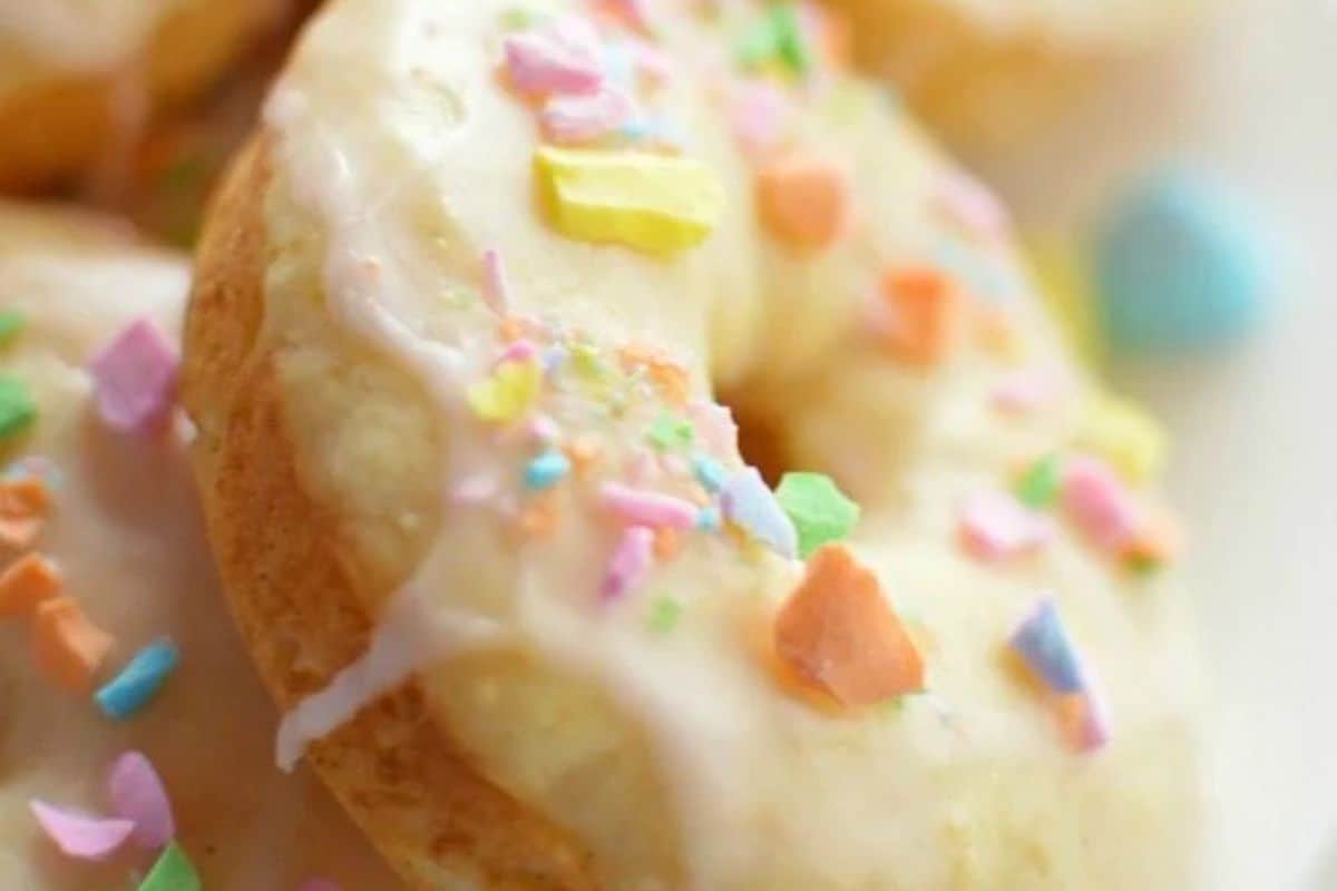 Close-up of a glazed donut topped with colorful, irregular-shaped sprinkles—perfect for a sweet and savory Valentine’s Day breakfast or to inspire creative brunch recipes.