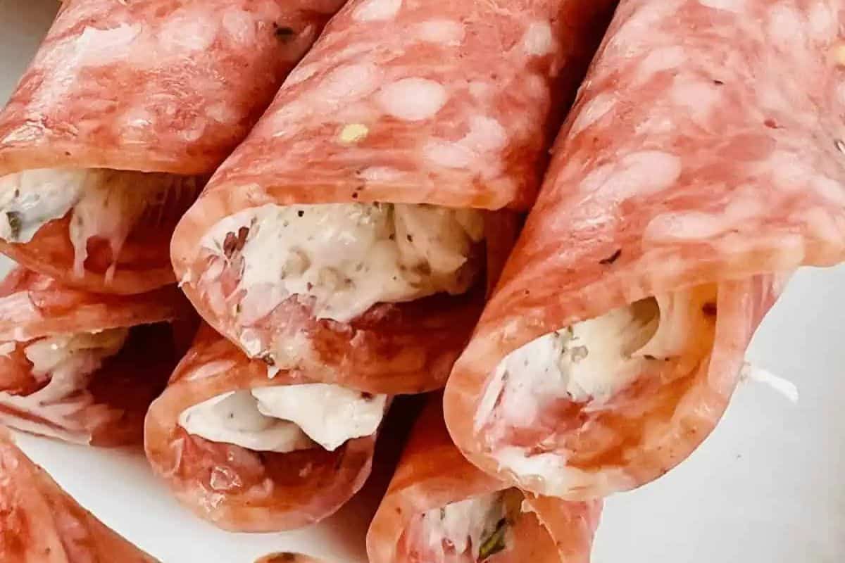 Salami slices rolled around a creamy filling with herbs, stacked on a plate, make for the perfect festive recipe to enjoy with your bestie this Galentine's Day.