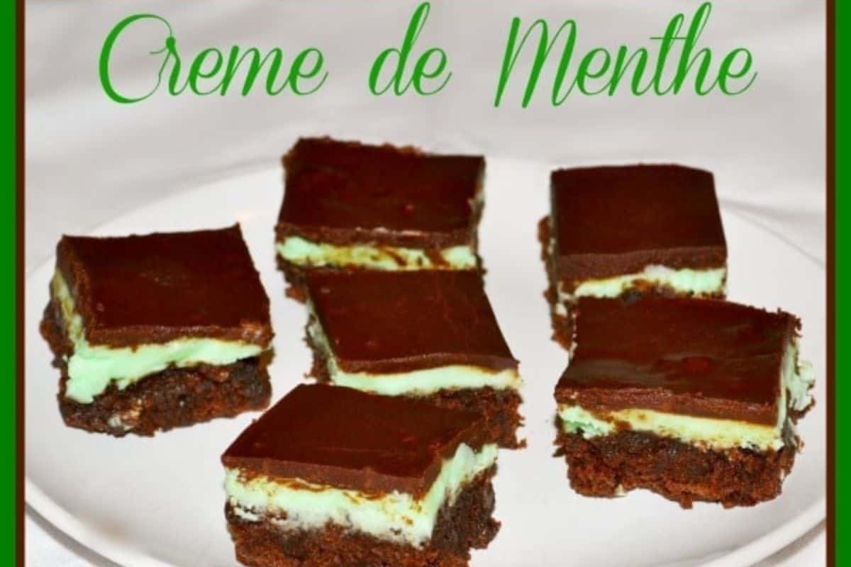 Six cute chocolate and mint layered brownies rest on a white plate, perfect for St. Patrick’s Day. The words "Creme de Menthe" elegantly hover above, making these sweets irresistible.