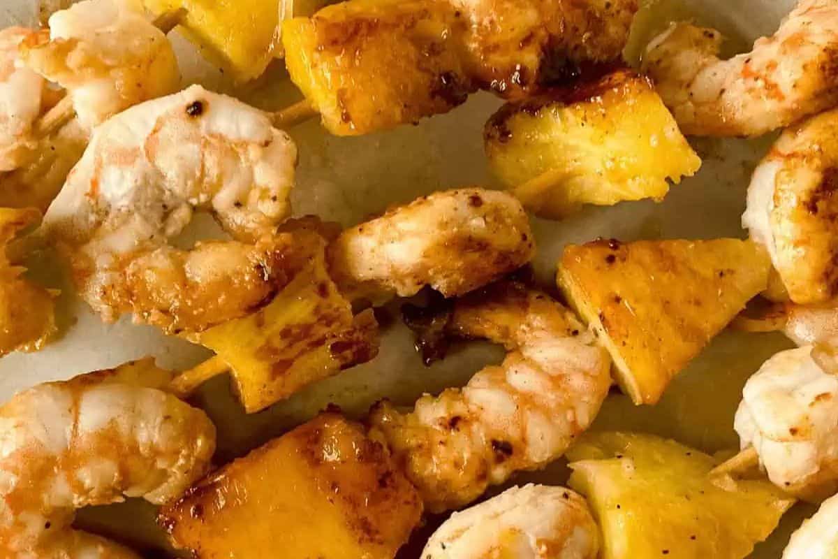 Grilled shrimp and pineapple skewers boast charred edges and a golden hue, delivering restaurant-quality flavor with ease.