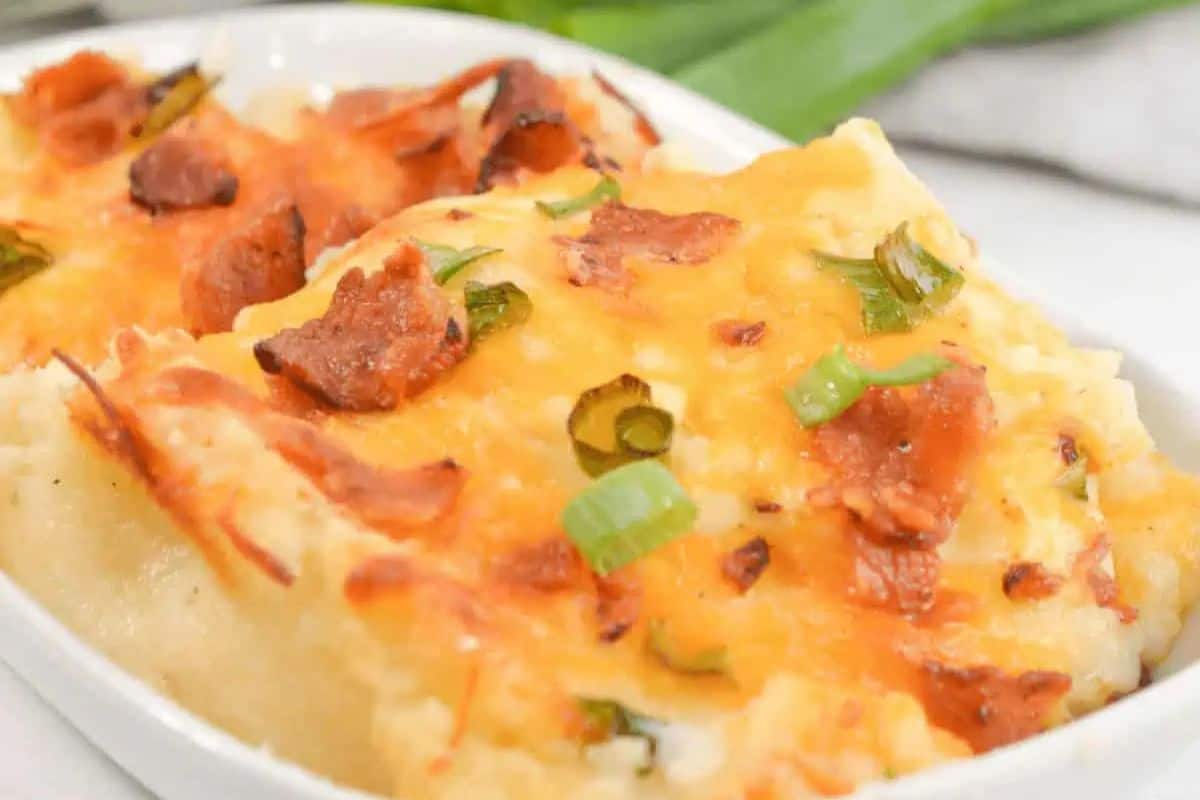 This crowd-pleasing loaded cheesy mashed potatoes features a golden layer of melted cheese and a sprinkle of chopped green onions on top—perfect for potluck recipes or adding a festive touch to your St. Patrick's Day celebration.