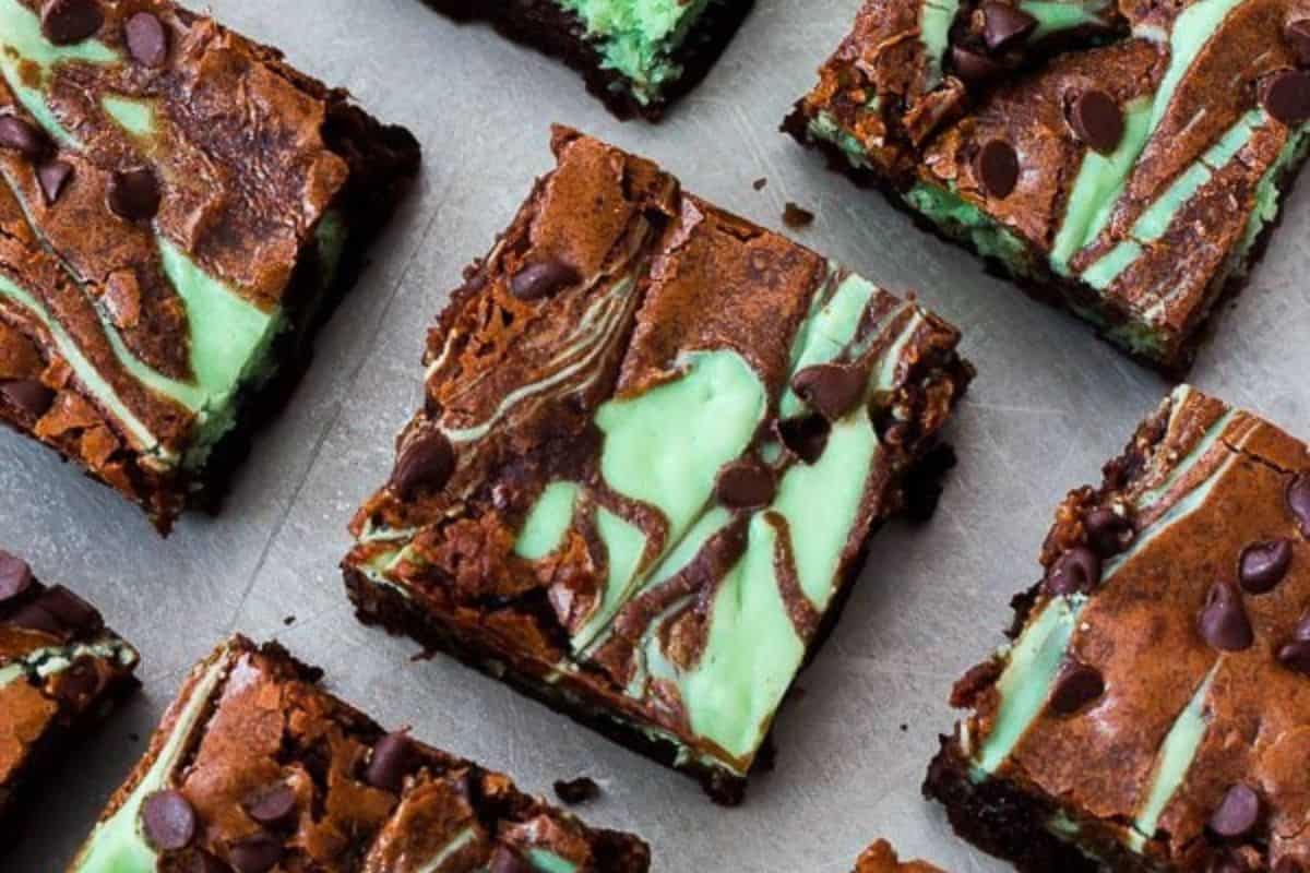 Brownies with a marbled pattern of green mint layers and chocolate chips on top, arranged on a baking tray, make the perfect St. Patrick’s Day sweets.
