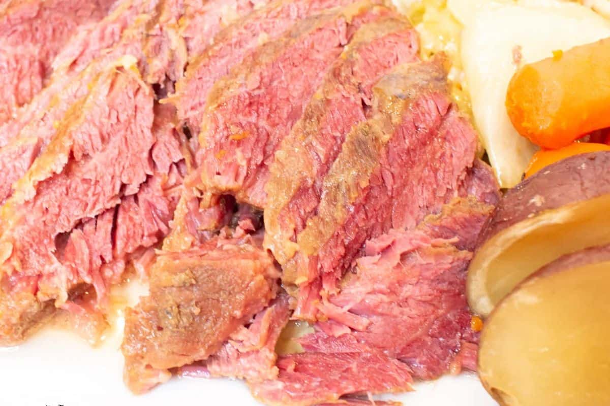 Celebrate the season with sliced corned beef, perfectly paired with boiled carrots, potatoes, and tender cabbage.