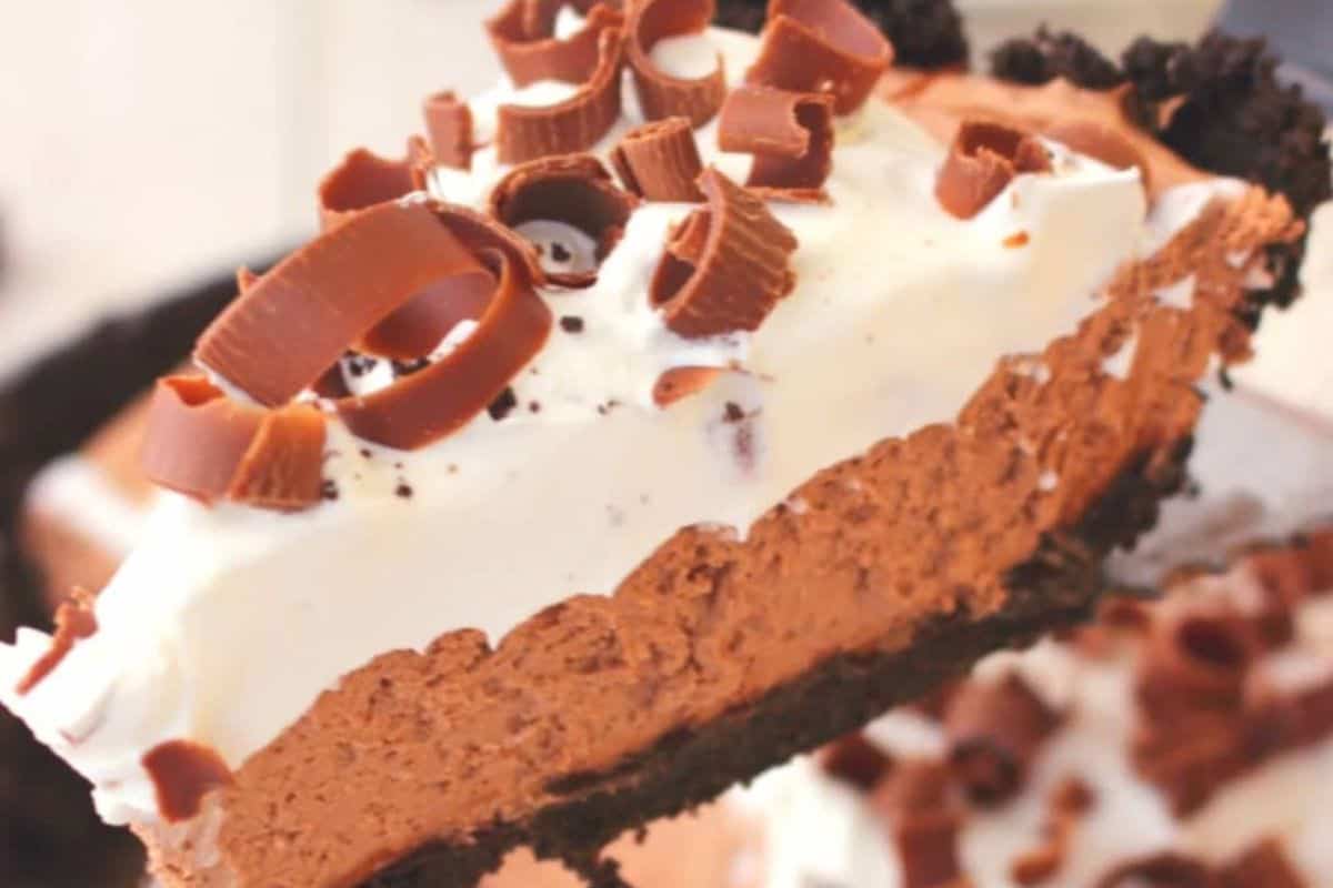 A slice of chocolate pie with a chocolate crust, topped with whipped cream and chocolate curls, elevates your no-bake treats and takes your dessert game to the next level.
