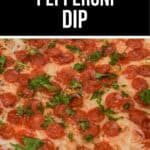 A glass dish filled with cheesy Pepperoni Dip, topped with sliced pepperoni, melted cheese, and chopped parsley.