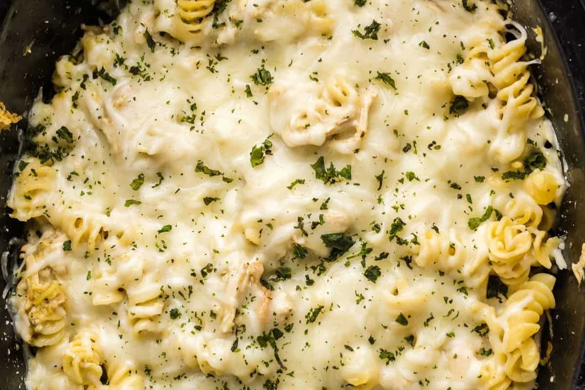 Baked rotini pasta covered in melted cheese and sprinkled with chopped herbs—an easy dinner perfect for fans of quick Dinner Recipes.