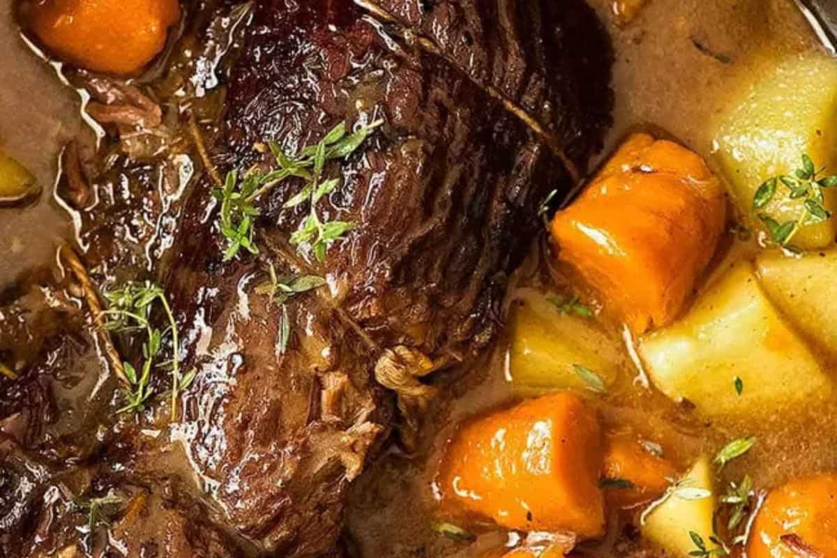 Close-up of some beef pot roast in a slow cooker.