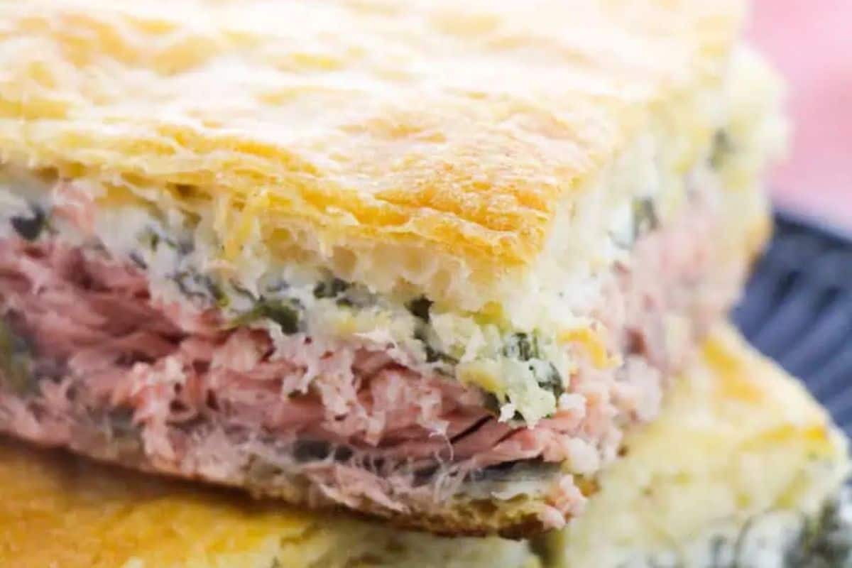 Close-up of an irresistible savory salmon en croute filled with, shredded salmon, cheese, and herbs.