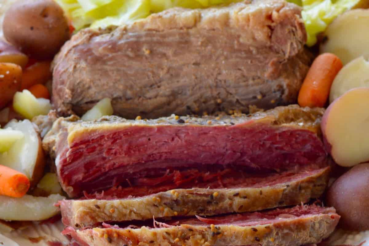 Savor the traditional corned beef with visible marbling, beautifully complemented by cooked carrots, potatoes, and cabbage. This delightful dish is a modern twist on classic cabbage recipes.