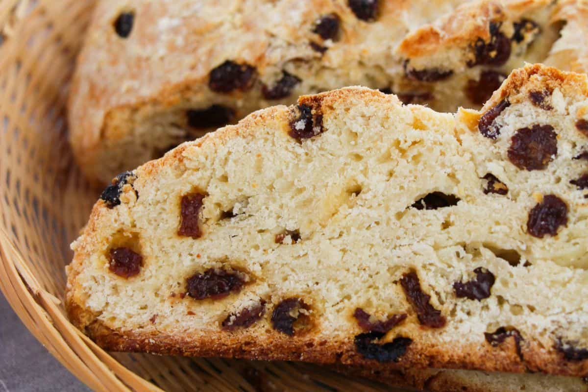Warm your soul with a close-up of sweet irish soda bread nestled in a wicker basket, offering the perfect blend of comfort food with an Irish-inspired twist.
