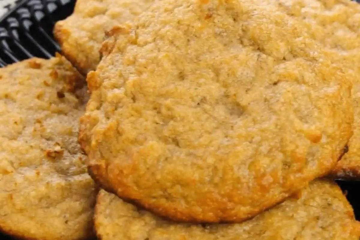 Close-up of several golden brown cookies stacked on a black plate—perfect creative treats for any occasion.