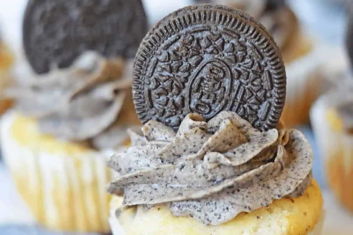 A sweeter vanilla cupcake topped with swirled cookies and cream frosting and crowned with a chocolate sandwich cookie. Perfect for any party!.