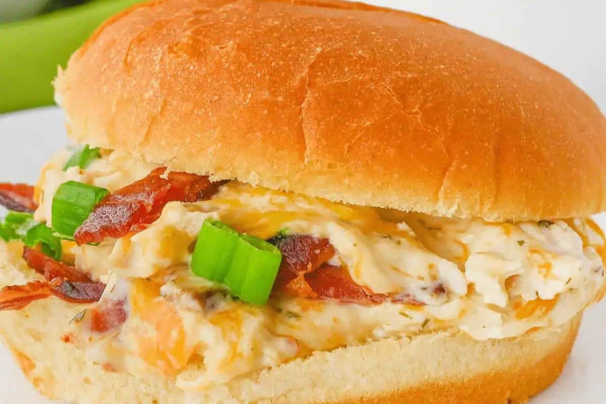 Close up of a sandwich with shredded chicken, ranch and cream cheese.