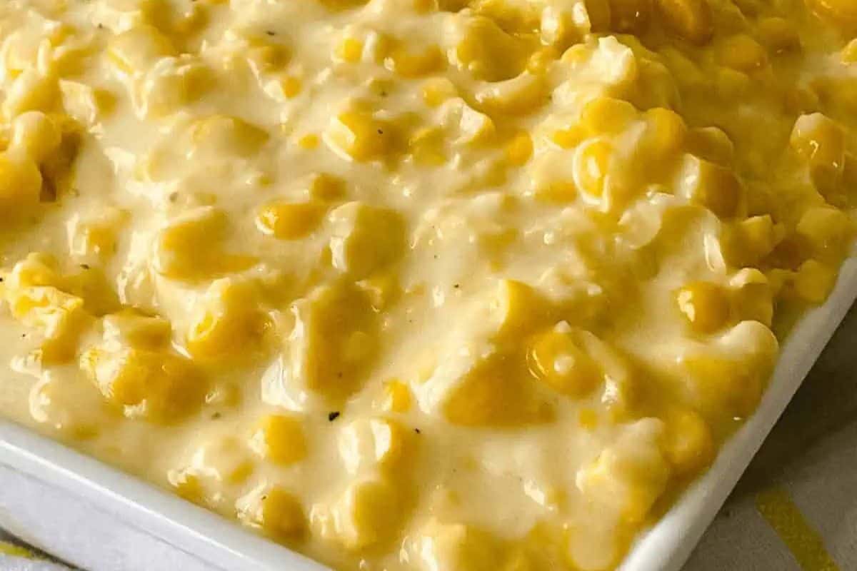 Close-up of creamy corn casserole in a white dish, showcasing its rich, smooth texture and vibrant kernels. Perfect for Easter side dishes that impress, this recipe promises delightful flavors in every bite.