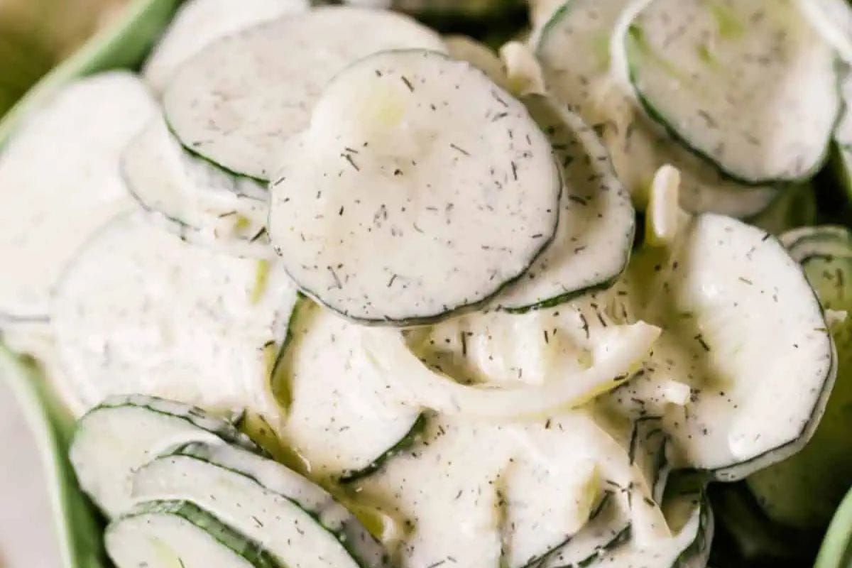 A bowl of sliced cucumbers mixed with onions and coated in a creamy dill dressing, this delightful dish is one of the best spring salad recipes to refresh your palate.