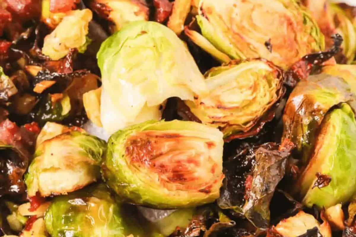 Close-up of roasted Brussels sprouts mixed with crispy bacon pieces, perfect for those seeking delicious recipes that add a touch of savory charm to any occasion.