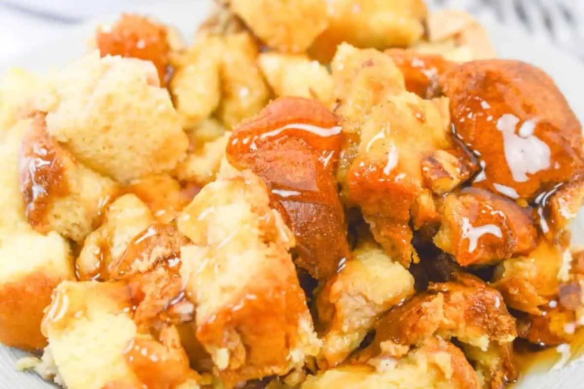 Close-up delicious french toast with apples drizzled with a maple syrup on a plate, perfect for indulging at Easter brunch.