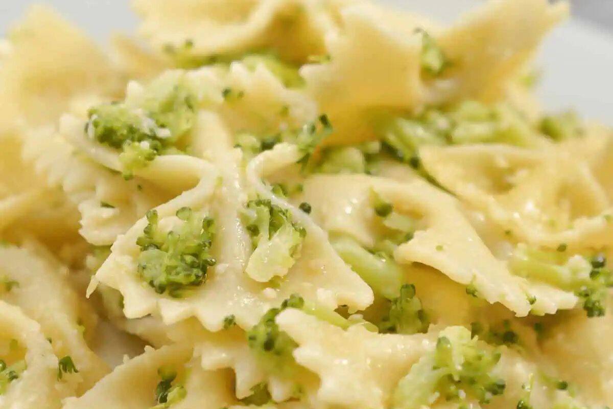 Close-up of farfalle pasta mixed with small pieces of broccoli and a light, creamy sauce—a perfect choice for meatless meals during Lent.