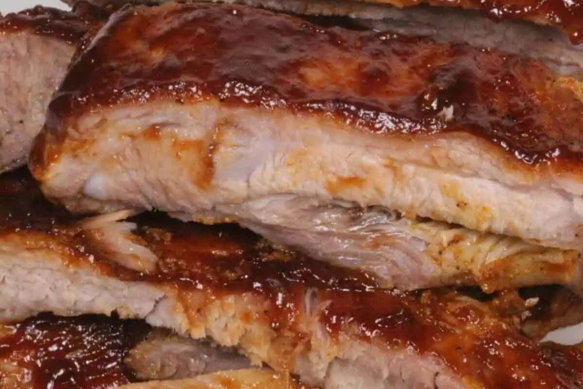 Close-up of barbecued pork ribs with a glossy, reddish-brown sauce coating—perfect for easy meals and game changing Instant Pot recipes.