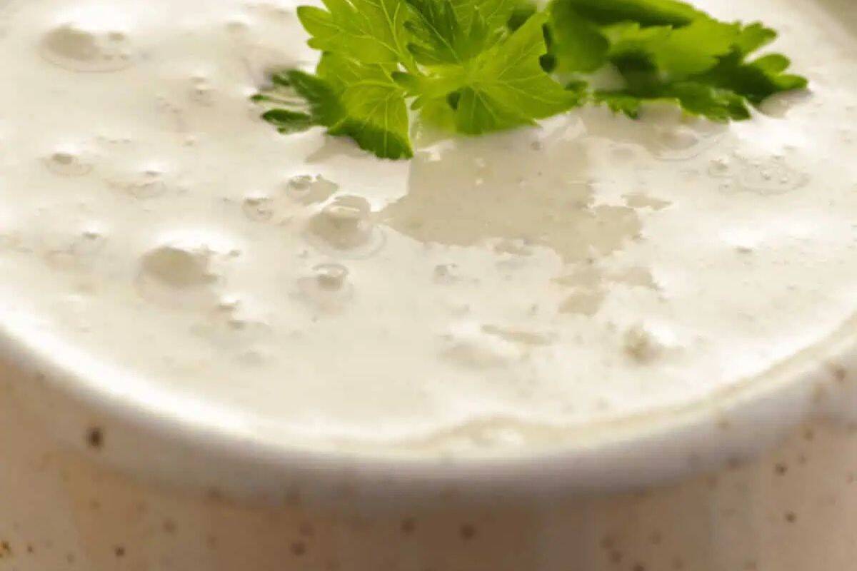 Creamy Blue Cheese Dressing or Sauce with visible chunks of blue cheese.