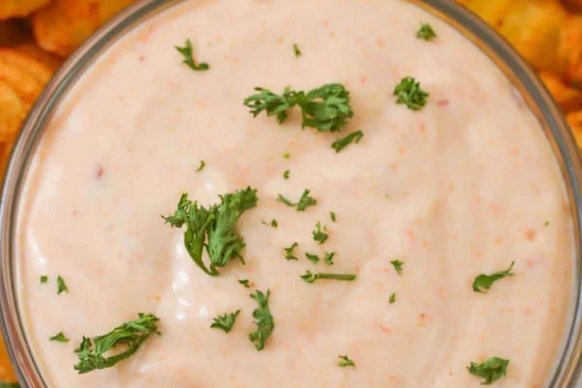 Smooth and creamy Boom Boom Sauce, garnished with fresh herbs.
