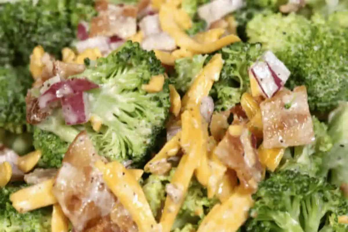 Broccoli Salad with Bacon and Cheese, a mix of fresh broccoli, crispy bacon, cheddar cheese, and red onion in a creamy dressing.