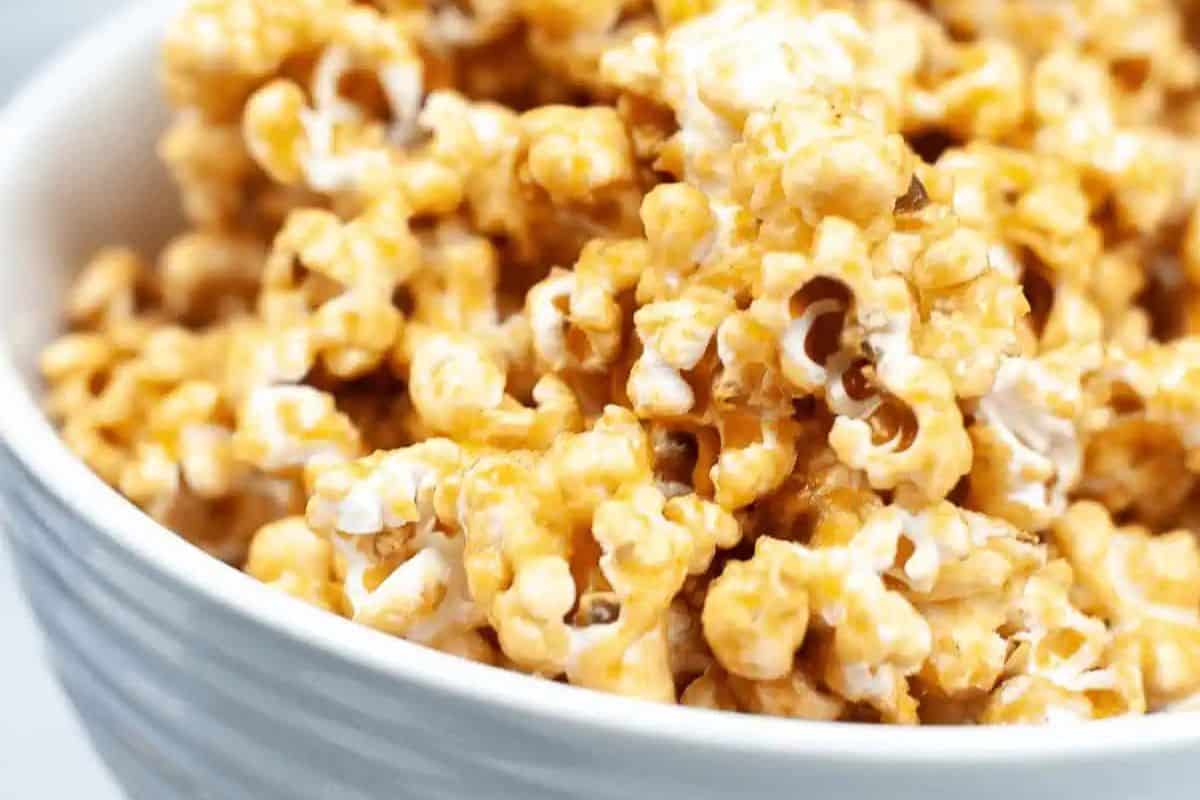 Close-up of a bowl filled with caramel-coated popcorn, a delightful treat perfect for fans of indulgent desserts and easy caramel recipes.