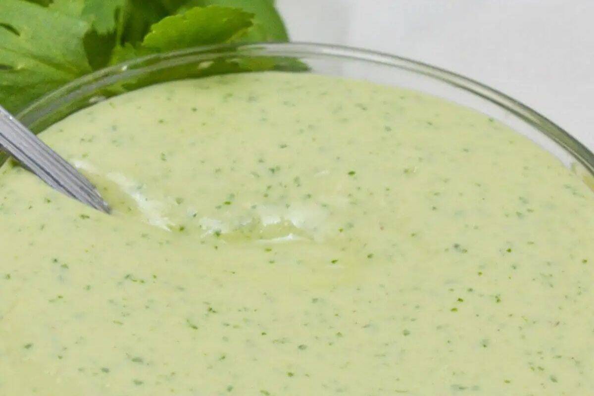 Creamy Cilantro Lime Sauce, featuring fresh cilantro and lime in a clear bowl.
